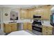 Bright kitchen features stainless appliances, light wood cabinets and white counters at 5404 Dunedin Ln, Charlotte, NC 28270