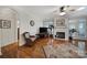 Living room with hardwood floors, fireplace, and a comfortable wicker chair at 5404 Dunedin Ln, Charlotte, NC 28270