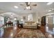 Open-concept living room with hardwood floors connecting to the dining area at 5404 Dunedin Ln, Charlotte, NC 28270
