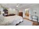 Spacious bedroom includes hardwood floors, a ceiling fan, and a view of an attached bathroom at 5404 Dunedin Ln, Charlotte, NC 28270