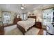 Comfortable primary bedroom with hardwood floors, complemented by a ceiling fan and natural light at 5404 Dunedin Ln, Charlotte, NC 28270