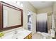 Bright bathroom with a decorative mirror, single sink vanity, and a shower with a patterned curtain at 551 Hemmings Nw Pl, Concord, NC 28027