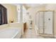 Bathroom featuring separate tub and shower with glass door, with natural lighting at 551 Hemmings Nw Pl, Concord, NC 28027