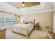 Comfortable bedroom with ceiling fan, large windows, and neutral decor at 551 Hemmings Nw Pl, Concord, NC 28027