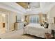 Cozy bedroom with ceiling fan, large window, and decorative mirror at 551 Hemmings Nw Pl, Concord, NC 28027