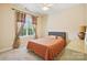 Comfortable bedroom with a gray headboard, neutral walls, and a window providing natural light at 551 Hemmings Nw Pl, Concord, NC 28027