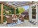 Outdoor deck featuring a seating area with wicker chairs, a table with flowers, and a trellis at 551 Hemmings Nw Pl, Concord, NC 28027