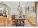 Spacious dining area with a large wooden table, chandelier, and an open layout perfect for entertaining at 551 Hemmings Nw Pl, Concord, NC 28027