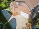 Aerial view of a brick home with an attached garage and well-maintained driveway and lawn at 551 Hemmings Nw Pl, Concord, NC 28027