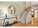 Grand foyer features hardwood floors, elegant staircase, stylish console table, and a welcoming ambiance at 551 Hemmings Nw Pl, Concord, NC 28027
