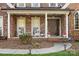 Inviting front porch with classic columns, comfortable seating, and a well-maintained entrance for curb appeal at 551 Hemmings Nw Pl, Concord, NC 28027