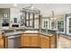 Kitchen with gray countertops and stainless steel dishwasher, adjacent to living room at 551 Hemmings Nw Pl, Concord, NC 28027
