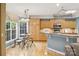 Bright kitchen with wooden cabinetry, gray countertops, and a cozy breakfast nook at 551 Hemmings Nw Pl, Concord, NC 28027