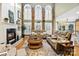 Bright and airy living room featuring high ceilings, large windows, a cozy fireplace, and comfortable seating at 551 Hemmings Nw Pl, Concord, NC 28027