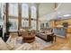 Spacious living room with tall windows, hardwood floors, and comfortable seating at 551 Hemmings Nw Pl, Concord, NC 28027