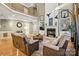 Bright living room with hardwood floors, large windows, fireplace, and neutral furnishings at 551 Hemmings Nw Pl, Concord, NC 28027
