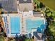Aerial view of a large community pool area with ample lounge chairs and manicured landscaping at 551 Hemmings Nw Pl, Concord, NC 28027