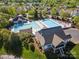 Overhead view of a large community pool area with extensive seating, clubhouse, and landscaping at 551 Hemmings Nw Pl, Concord, NC 28027