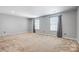 Bedroom with two windows, neutral walls, and carpet flooring at 5628 Selkirkshire Rd, Charlotte, NC 28278