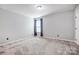 Bedroom with neutral walls, carpet flooring, natural light, and standard closet at 5628 Selkirkshire Rd, Charlotte, NC 28278