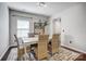 Dining room featuring a wooden table with seating for six, modern decor, and hardwood floors at 5628 Selkirkshire Rd, Charlotte, NC 28278