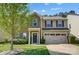 Charming two-story home featuring a stone and siding exterior, well-maintained landscaping, and an attached two-car garage at 5628 Selkirkshire Rd, Charlotte, NC 28278