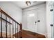 Inviting foyer with hardwood floors, staircase with decorative iron railing and a front door with window panes at 5628 Selkirkshire Rd, Charlotte, NC 28278