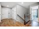 Upstairs hallway with wood floors and views into bedroom and landing at 5628 Selkirkshire Rd, Charlotte, NC 28278