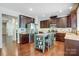 Spacious kitchen with dark cabinets, stainless steel appliances, granite countertops, and a central island at 5628 Selkirkshire Rd, Charlotte, NC 28278