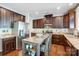 Functional kitchen featuring dark cabinets, granite countertops, stainless steel appliances, and a kitchen island at 5628 Selkirkshire Rd, Charlotte, NC 28278
