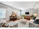 Living room featuring a stylish brick accent wall, modern decor, and hardwood flooring at 5628 Selkirkshire Rd, Charlotte, NC 28278