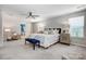 Spacious main bedroom with neutral colors, fan, sitting area, and access to the main bathroom at 5628 Selkirkshire Rd, Charlotte, NC 28278