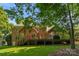 Exterior back view of brick home with deck and stairwell to backyard at 6017 Summerston Pl, Charlotte, NC 28277