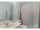This bathroom features a single sink vanity, a toilet, and a shower and bathtub with neutral tones, creating a functional space at 6017 Summerston Pl, Charlotte, NC 28277