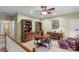 Spacious bonus room with hardwood bookcases, a round wooden table and a ceiling fan at 6017 Summerston Pl, Charlotte, NC 28277