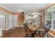 An open floor plan features hardwood floors, a staircase, and a dining area flowing into the kitchen at 6017 Summerston Pl, Charlotte, NC 28277