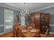 Formal dining room featuring elegant chandelier, hardwood floors, and large window at 6017 Summerston Pl, Charlotte, NC 28277