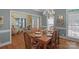 Well-lit dining room featuring hardwood floors, chandelier, and view to entry at 6017 Summerston Pl, Charlotte, NC 28277