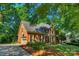Spacious brick home with an attached garage, surrounded by a lush, green landscape at 6017 Summerston Pl, Charlotte, NC 28277