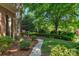 Well-maintained front yard with a walkway, mature trees, and elegant landscaping at 6017 Summerston Pl, Charlotte, NC 28277