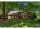 Beautiful brick home featuring mature trees, lush lawn, and classic architectural details at 6017 Summerston Pl, Charlotte, NC 28277