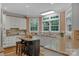 Bright kitchen features white cabinets, stainless steel appliances, granite countertops, and a center island with bar stool seating at 6017 Summerston Pl, Charlotte, NC 28277