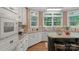 Well-lit kitchen showcases white appliances, granite countertops, backsplash, and ample cabinet space at 6017 Summerston Pl, Charlotte, NC 28277