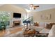 Bright living room with fireplace, piano, hardwood floors, and vaulted ceilings at 6017 Summerston Pl, Charlotte, NC 28277