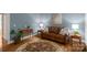 Comfortable living room with leather sofa, area rug, and stylish decor at 6017 Summerston Pl, Charlotte, NC 28277