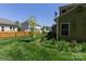 The property includes a well-kept lawn with a classic wooden fence and young trees at 602 Black Maple Dr, Kannapolis, NC 28081