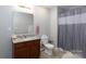 Well-lit bathroom featuring a granite vanity top, modern fixtures, and a shower with a curtain at 602 Black Maple Dr, Kannapolis, NC 28081
