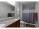 Bathroom featuring a double vanity, granite counters, neutral walls, and a shower/tub with curtain at 602 Black Maple Dr, Kannapolis, NC 28081