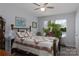 Bright bedroom with a ceiling fan, large window, and a bed with decorative pillows and a quilt at 602 Black Maple Dr, Kannapolis, NC 28081