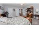 Spacious bedroom with a large bed, neutral walls, and a variety of doorways and storage at 602 Black Maple Dr, Kannapolis, NC 28081